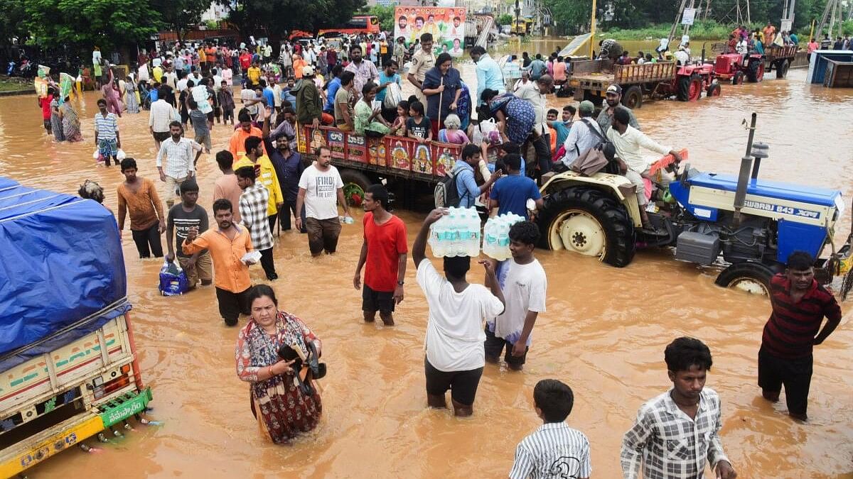 <div class="paragraphs"><p>People wade through waterlogged roads following heavy rains in Vijayawada, in the southern state of Andhra Pradesh, India, September 4, 2024.</p></div>