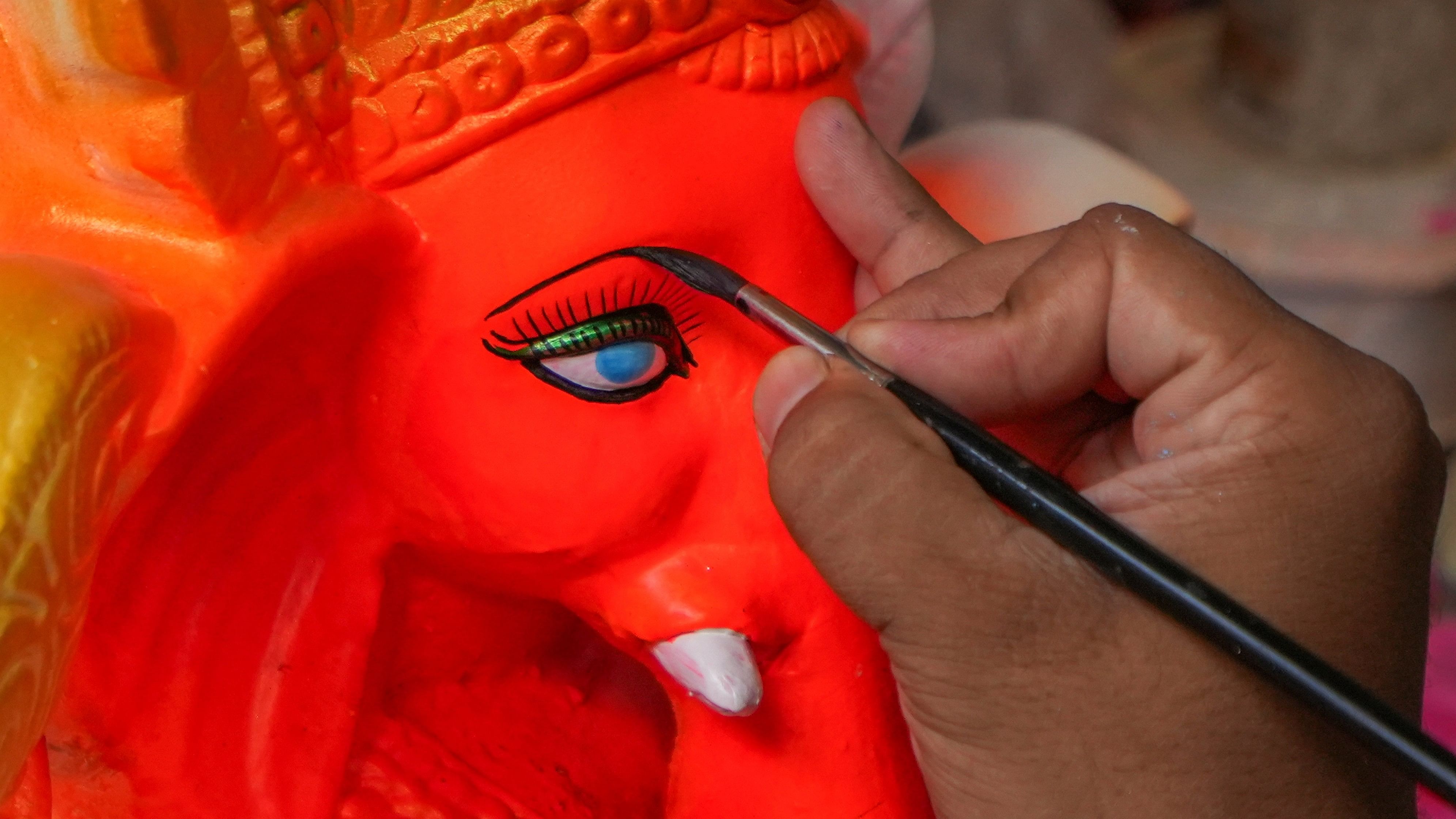 <div class="paragraphs"><p>An artisan gives finishing touches on a clay idol of Lord Ganesh ahead of Ganesh Chaturthi festival, in Kolkata, Wednesday, Sept 4, 2024</p></div>