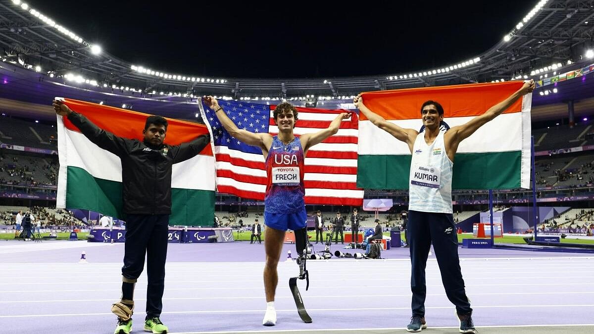 <div class="paragraphs"><p>Ezra Frech of United States celebrates winning gold with silver medallist Sharad Kumar of India and bronze medallist Mariyappan Thangavelu of India.</p></div>