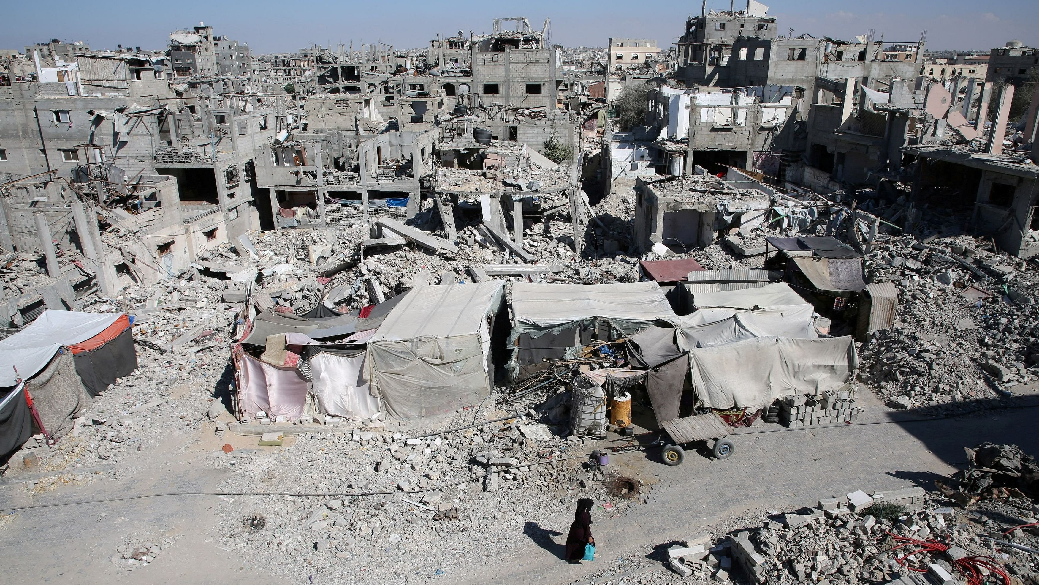 <div class="paragraphs"><p>A Palestinian walks past the rubble of houses destroyed by Israeli strikes, amid Israel-Hamas conflict, in Khan Younis in the southern Gaza Strip, September 4, 2024. </p></div>