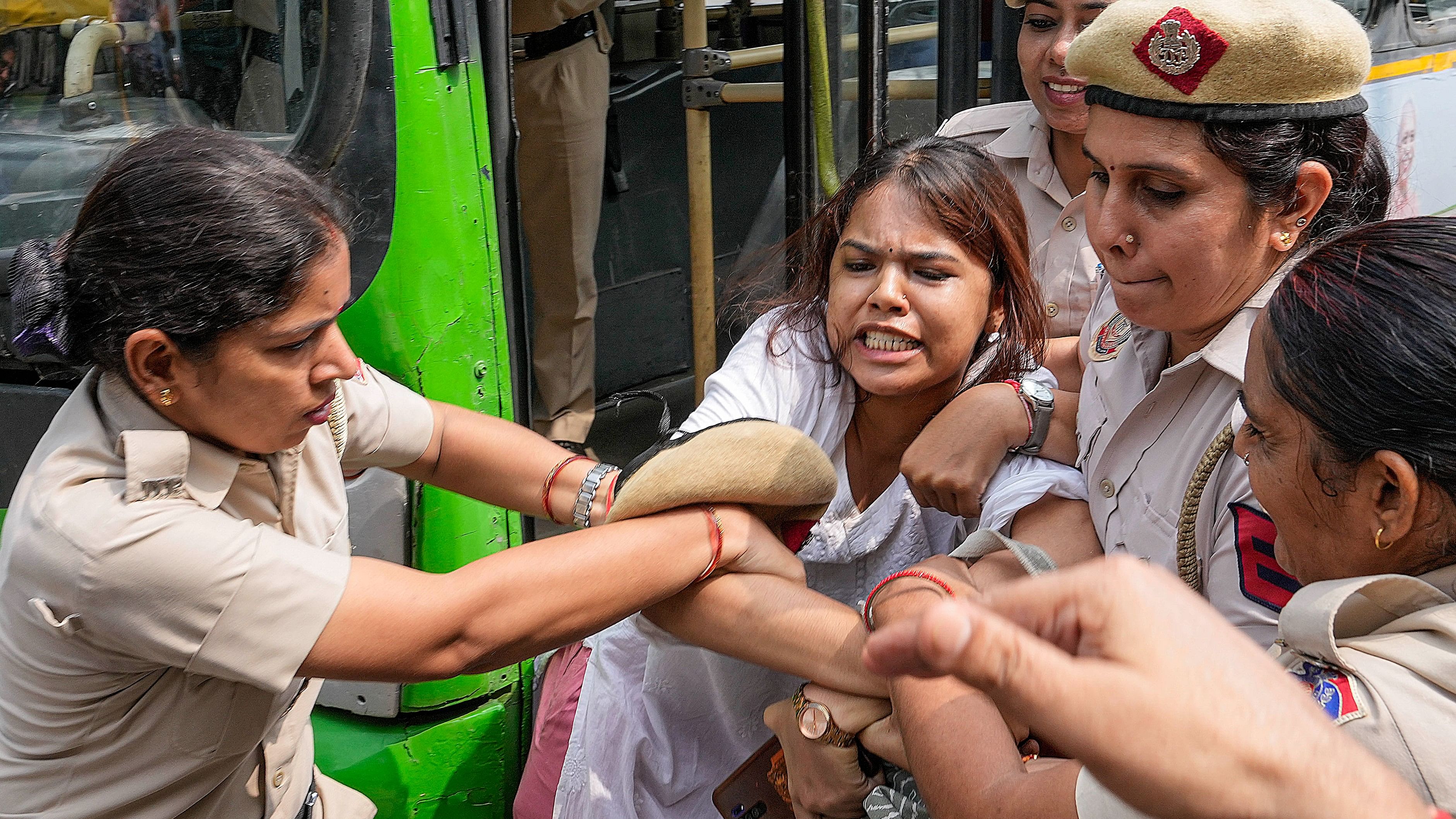 <div class="paragraphs"><p>Police personnel detain an activist during a protest by teachers and students of various organisations against the National Education Policy (NEP) 2020 and National Testing Agency (NTA) on Teachers' Day, in New Delhi, Thursday</p></div>