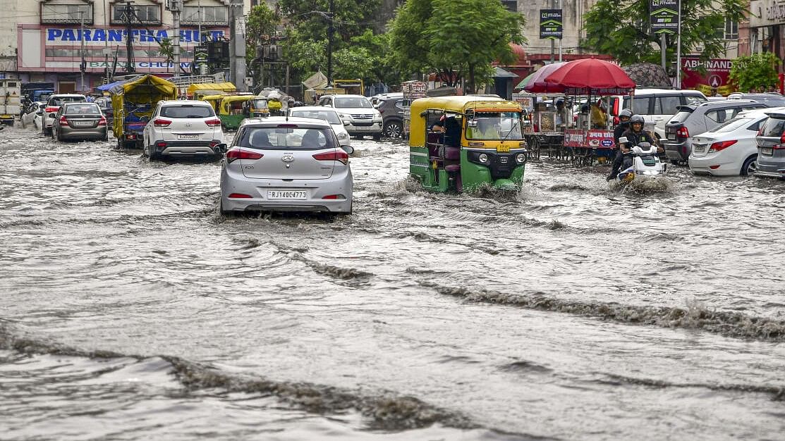 <div class="paragraphs"><p>Vehicles pass through a waterlogged street after heavy monsoon rains, in Jaipur.&nbsp;</p></div>