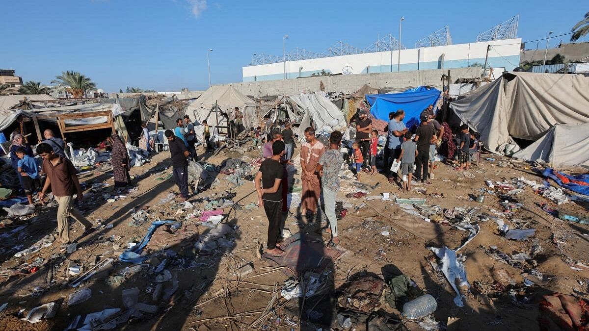 <div class="paragraphs"><p>Palestinians inspect the site of an Israeli strike.</p></div>