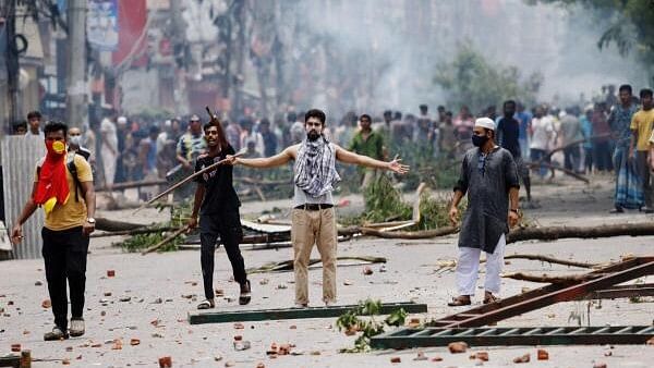 <div class="paragraphs"><p>Protesters clash with Border Guard Bangladesh and the police as violence erupts across the country after anti-quota protests by students, in Dhaka, Bangladesh.</p></div>