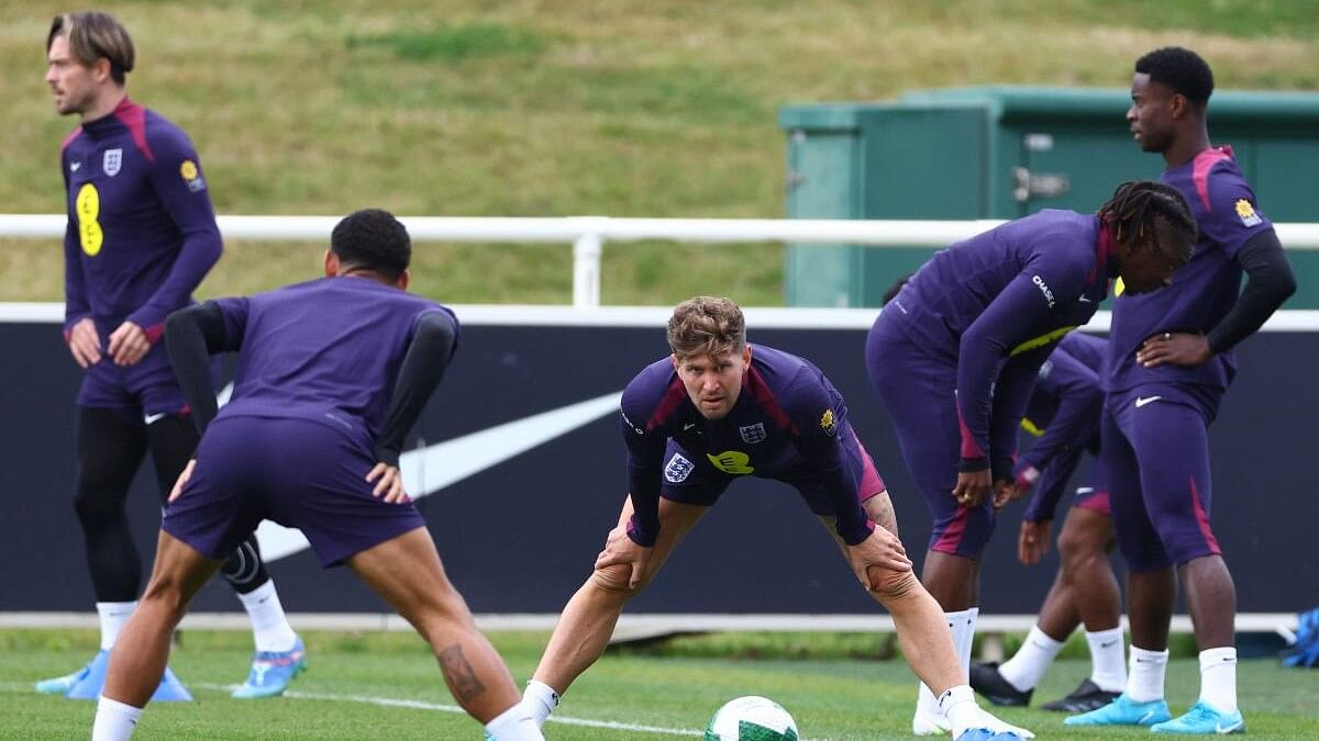 <div class="paragraphs"><p>England's John Stones with teammates during training.</p></div>