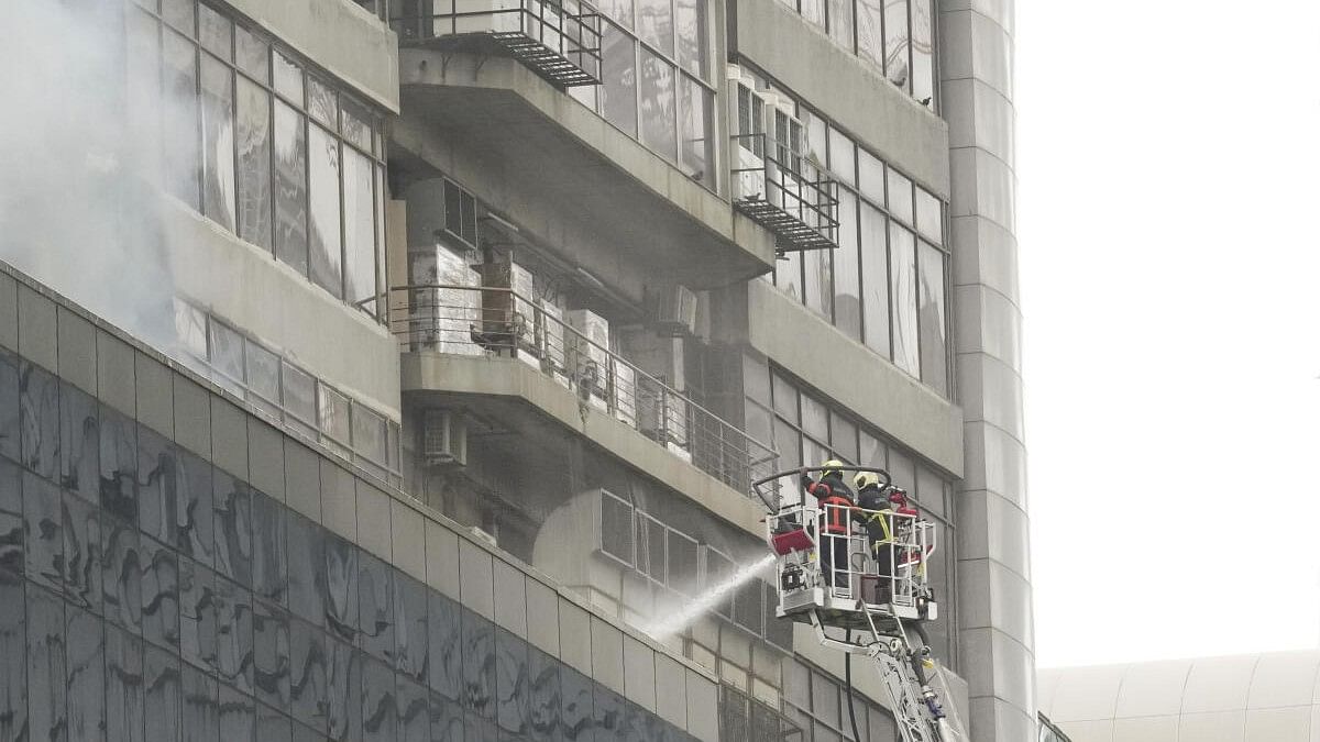 <div class="paragraphs"><p>Firefighters try to douse a fire that broke out at Times Tower building in Kamala Mill compound</p></div>