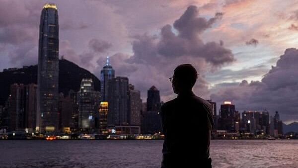 <div class="paragraphs"><p>A man stands in front of Victoria Harbour, with the Central financial district in the background, as typhoon Yagi approaches in Hong Kong, China.&nbsp;</p></div>