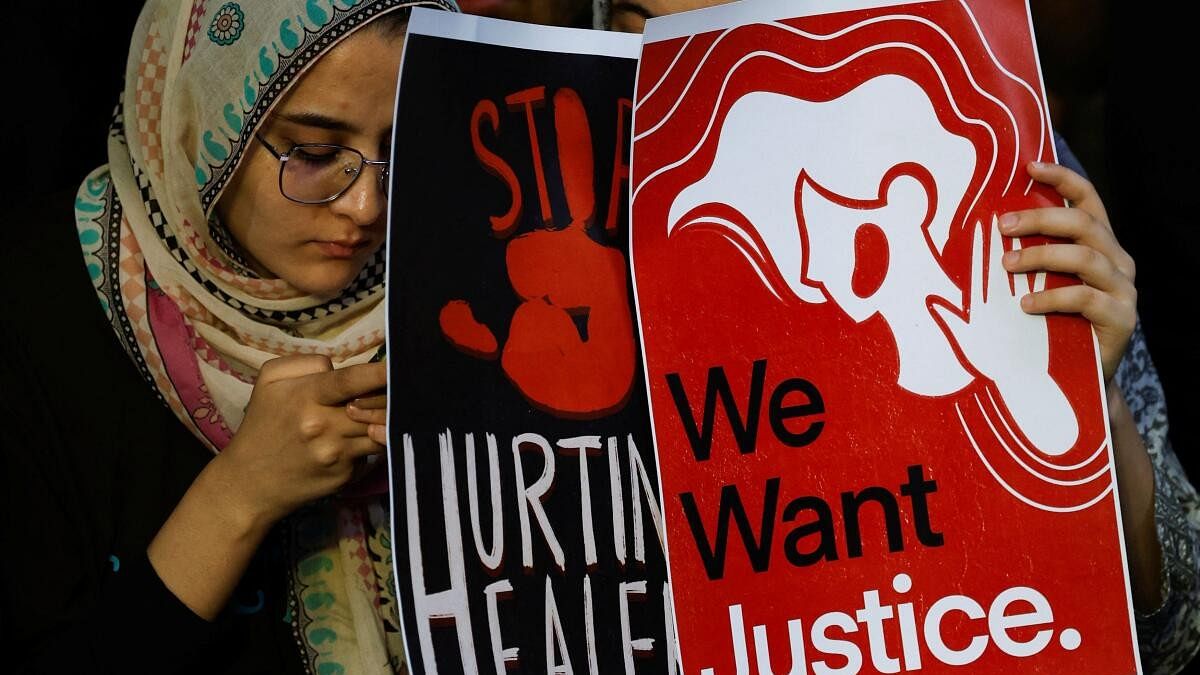 <div class="paragraphs"><p>Students hold posters as they attend a protest against what they say was rape and murder of a trainee doctor, inside the premises of R G Kar Medical College and Hospital in Kolkata.&nbsp;</p></div>