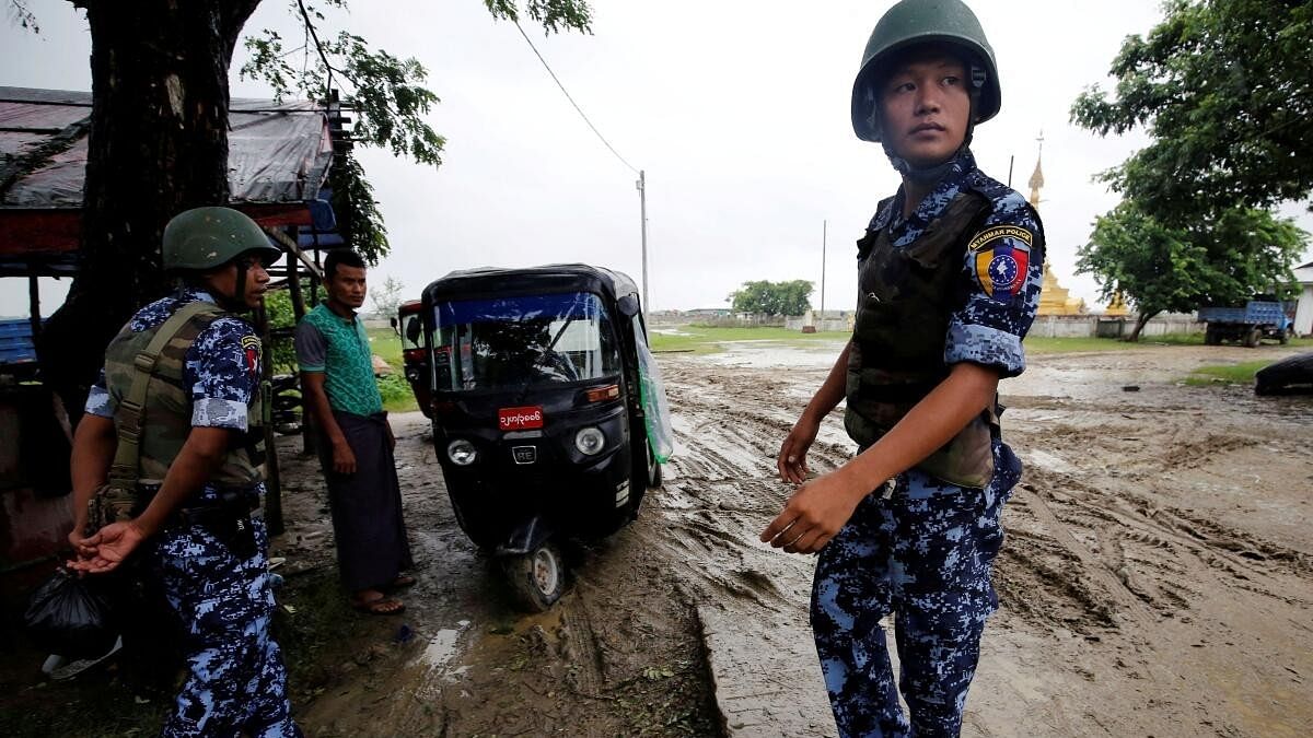 <div class="paragraphs"><p>Myanmar police officer stands guard in Maungdaw, Rakhine.</p></div>