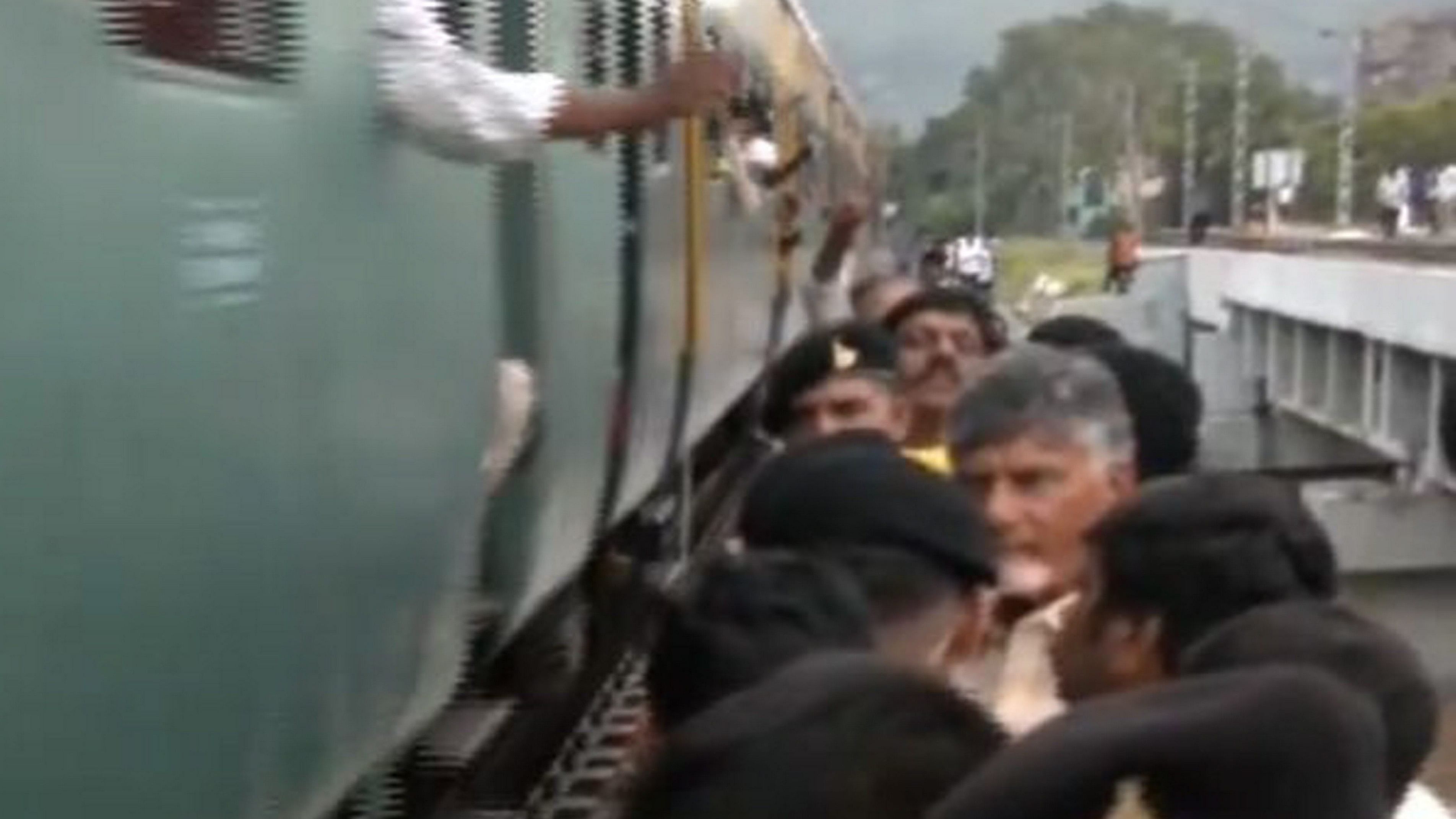 <div class="paragraphs"><p>Andhra Pradesh Chief Minister N Chandrababu Naidu stands on a bridge even as a train passes near him during flood inspection, in Vijayawada, Thursday, Sept. 5, 2024. </p></div>