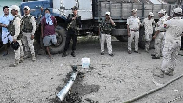 <div class="paragraphs"><p>Police personnel and locals stand near the remains of a missile after it struck in Moirang, Manipur, India, September 6, 2024.</p></div>