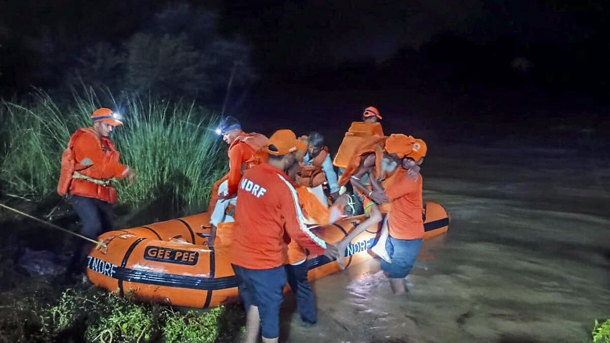 <div class="paragraphs"><p>NDRF personnel evacuate people from a flood-affected area of Telangana.&nbsp;</p></div>