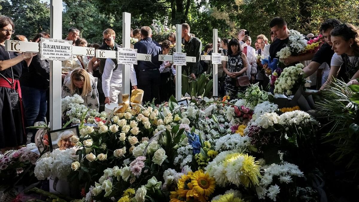 <div class="paragraphs"><p>People attend a funeral ceremony for Yevhenia Bazylevych and her three daughters, killed during the Russian missile attack on September 4 as Yaroslav her husband, was the only survivor out of the entire family, amid Russia's attack on Ukraine, in Lviv, Ukraine September 6, 2024.</p></div>