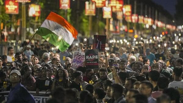 <div class="paragraphs"><p>People take part in a protest march over the alleged sexual assault and murder of a trainee doctor, in Kolkata, Sunday, Sept. 8, 2024. </p></div>