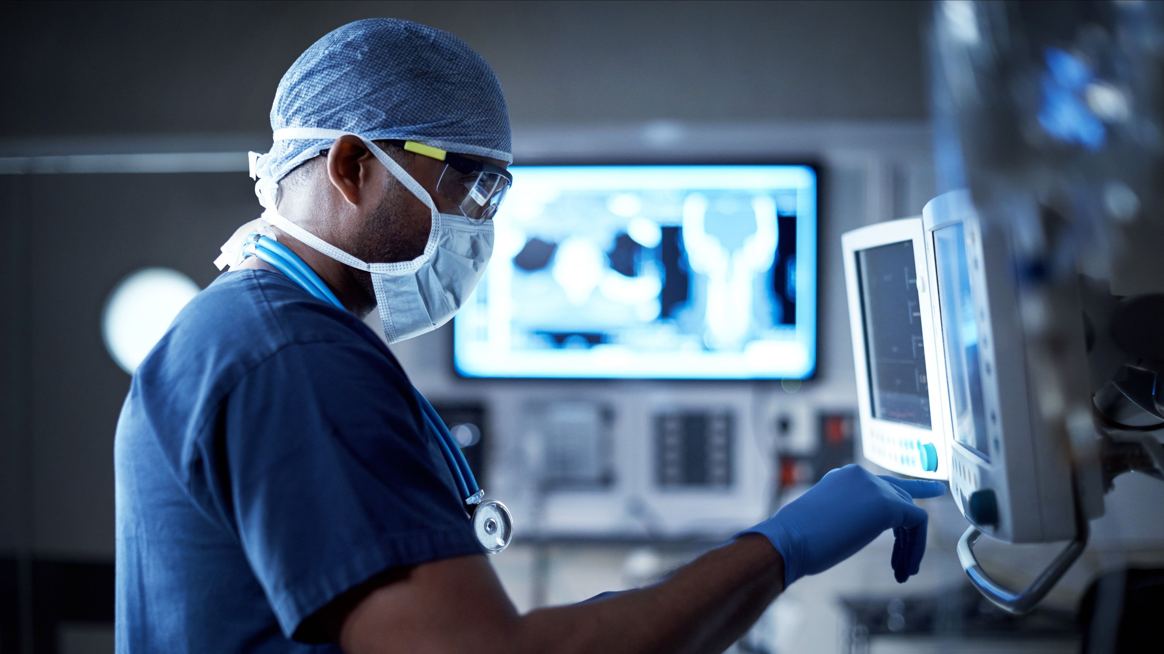 Shot of a surgeon looking at a monitor in an operating room
Vigilantly monitoring his patient's vitals