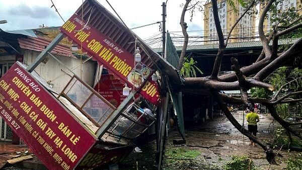 <div class="paragraphs"><p>A man walks past a devastated area following the impact of Typhoon Yagi, in Hanoi, Vietnam.&nbsp;</p></div>