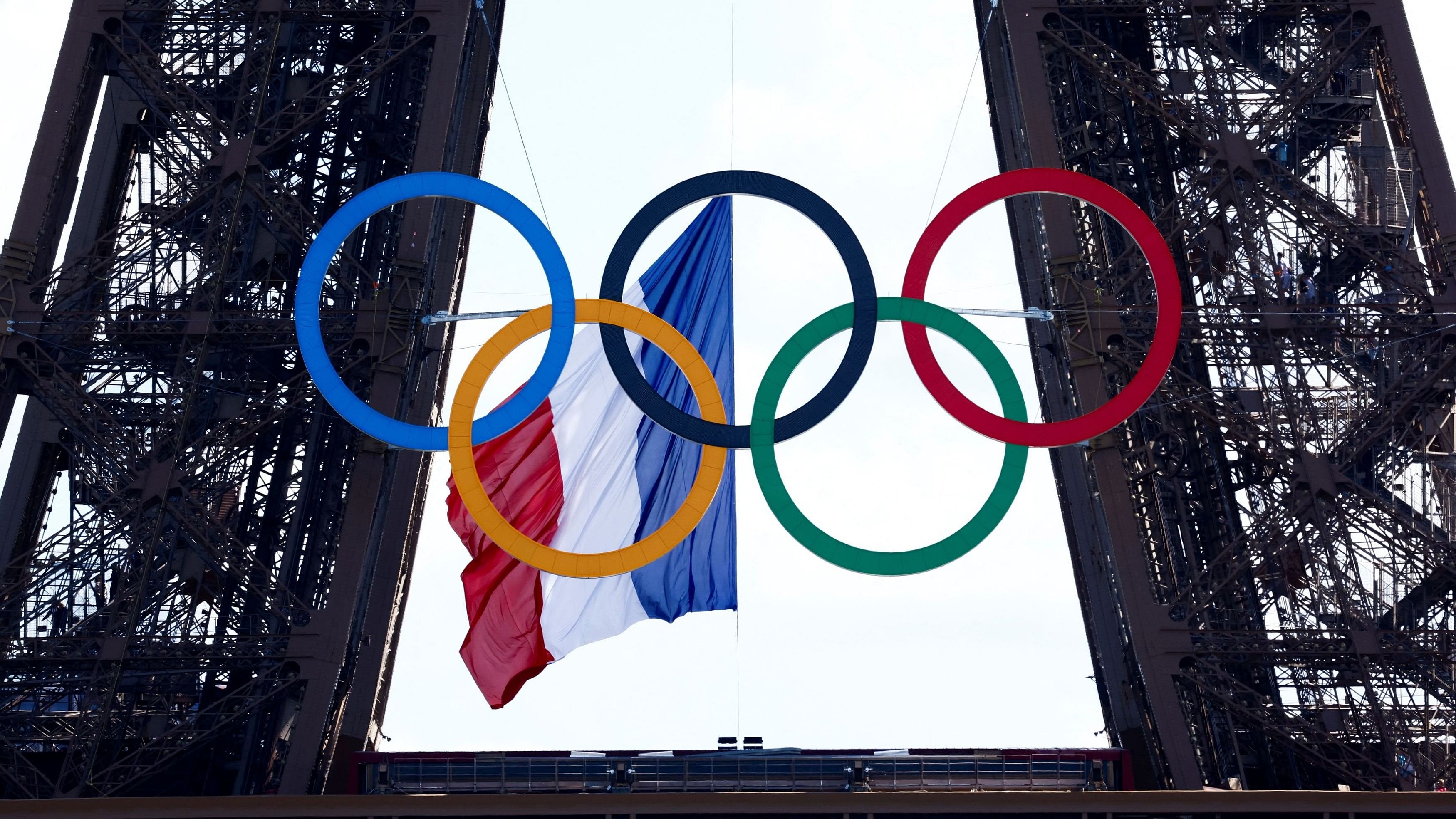 <div class="paragraphs"><p>The French flag flutters at the Eiffel Tower, with the Olympic rings displayed.</p></div>