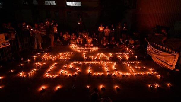 <div class="paragraphs"><p>Doctors and health workers light candles depicting "We Want Justice" at the RG Kar Medical College and Hospital against the rape and murder of a trainee woman doctor inside the hospital premises, in Kolkata.</p></div>