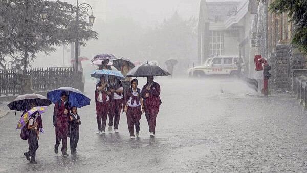 <div class="paragraphs"><p>Students use umbrellas to shield themselves during rain, in Shimla, Saturday.&nbsp;</p></div>