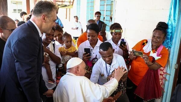 <div class="paragraphs"><p>Pope Francis blesses a child at the Holy Trinity Humanities School in Baro, near Vanimo, Papua New Guinea.</p></div>