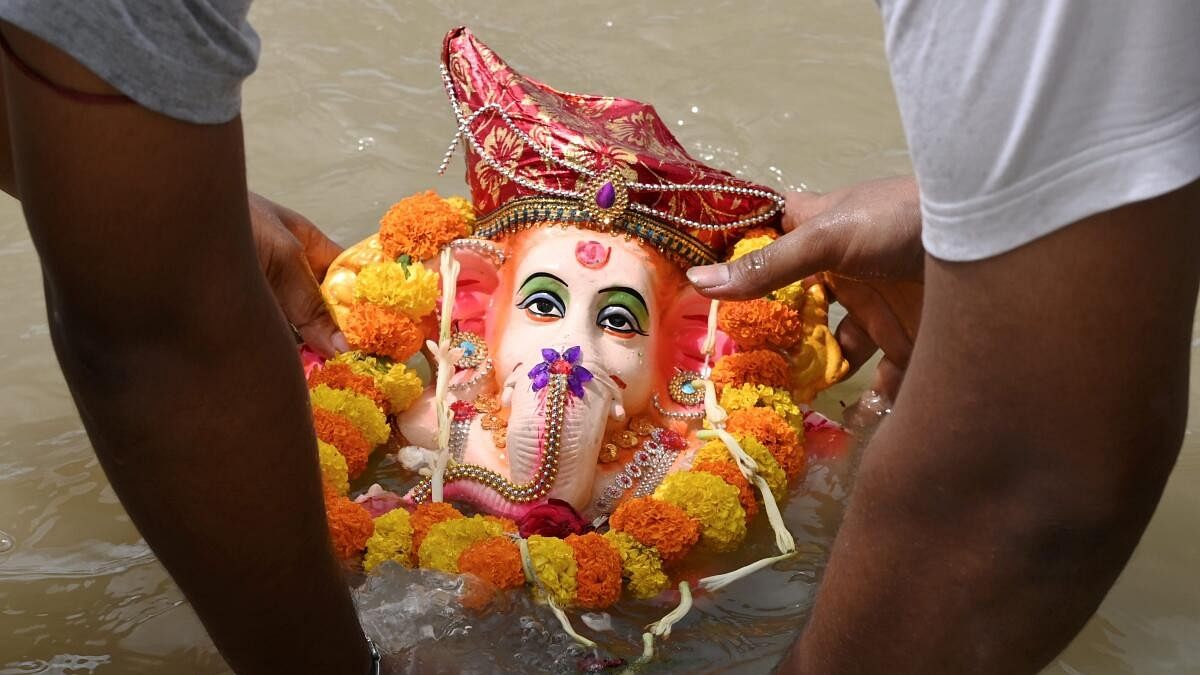 <div class="paragraphs"><p>A devotee immerses Lord Ganesha idol.</p></div>