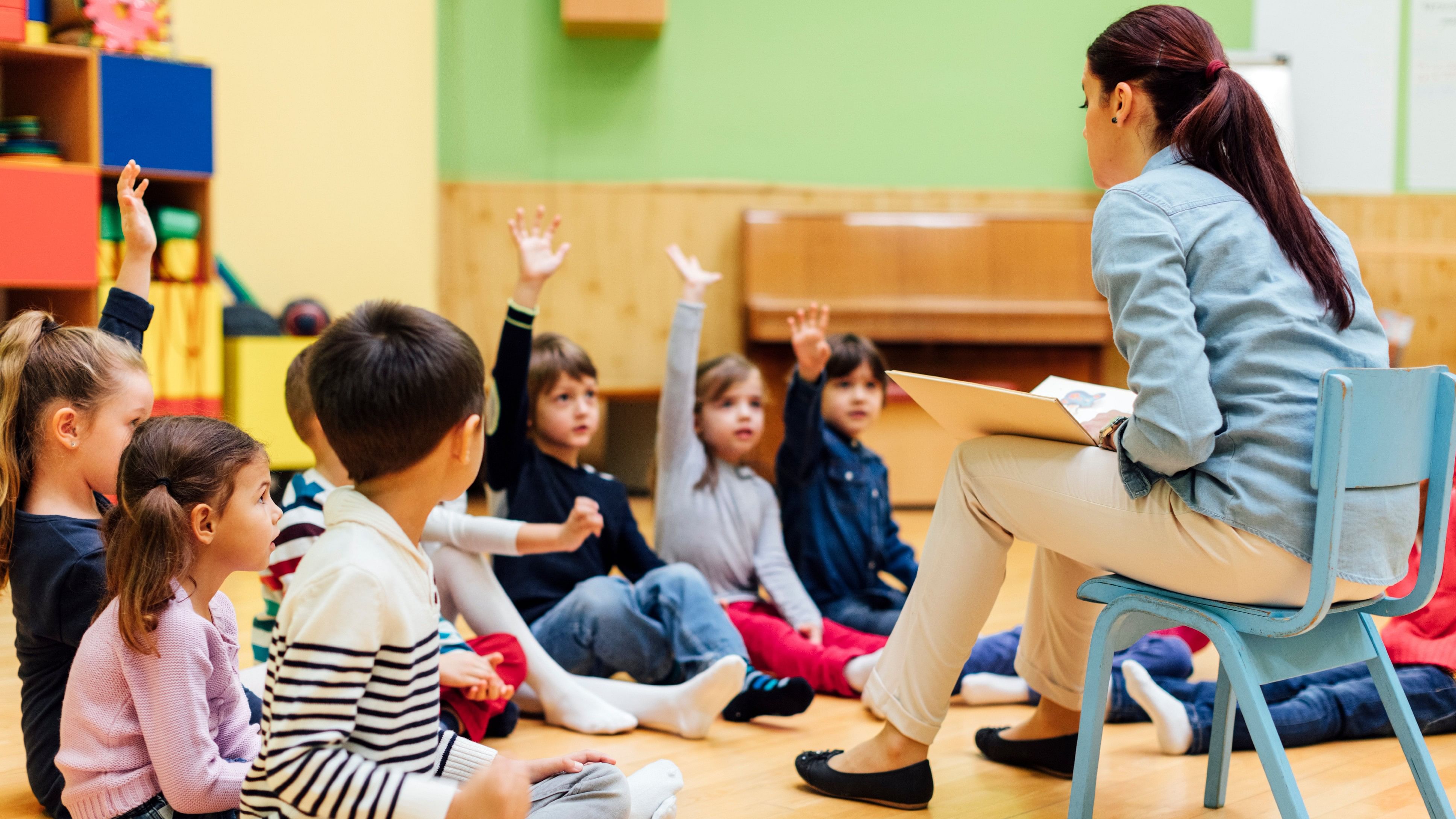 <div class="paragraphs"><p>Preschool teacher telling a story to children. Children answering the questions. Children sitting on the floor. Models in this shot are part of real kindergarten group and their teacher. Happy beautiful diverse, Teachers</p></div>