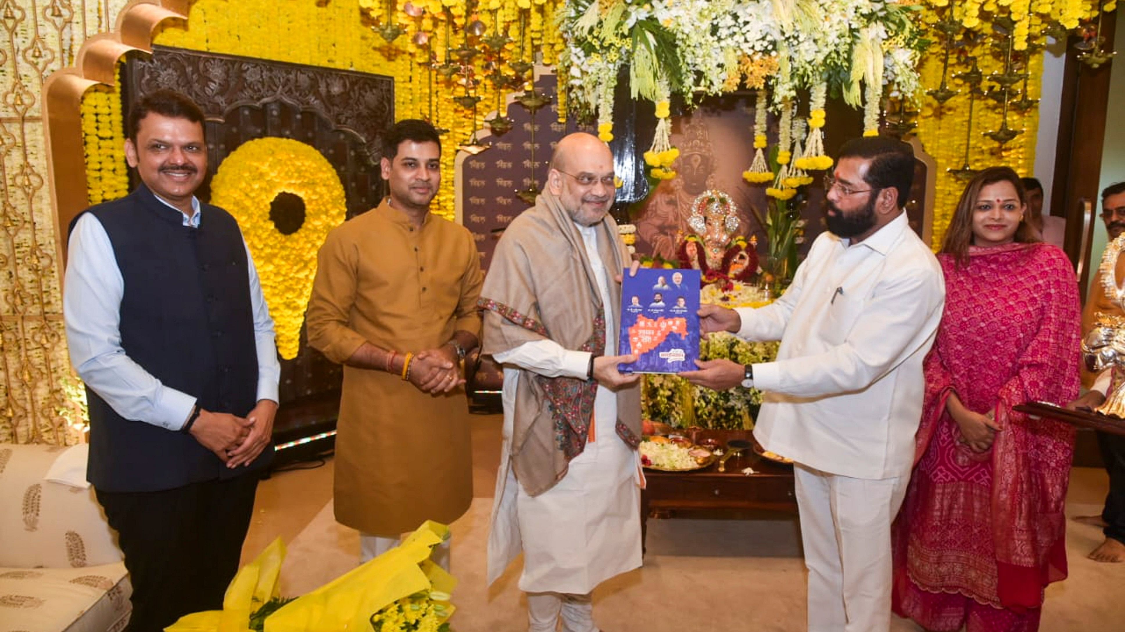 <div class="paragraphs"><p>Home Minister Amit Shah meets Maharashtra Chief Minister Eknath Shinde during Ganesh Chaturthi festival, in Mumbai, Monday, Sept 9, 2024. Deputy CM Devendra Fadnavis is also seen. </p></div>