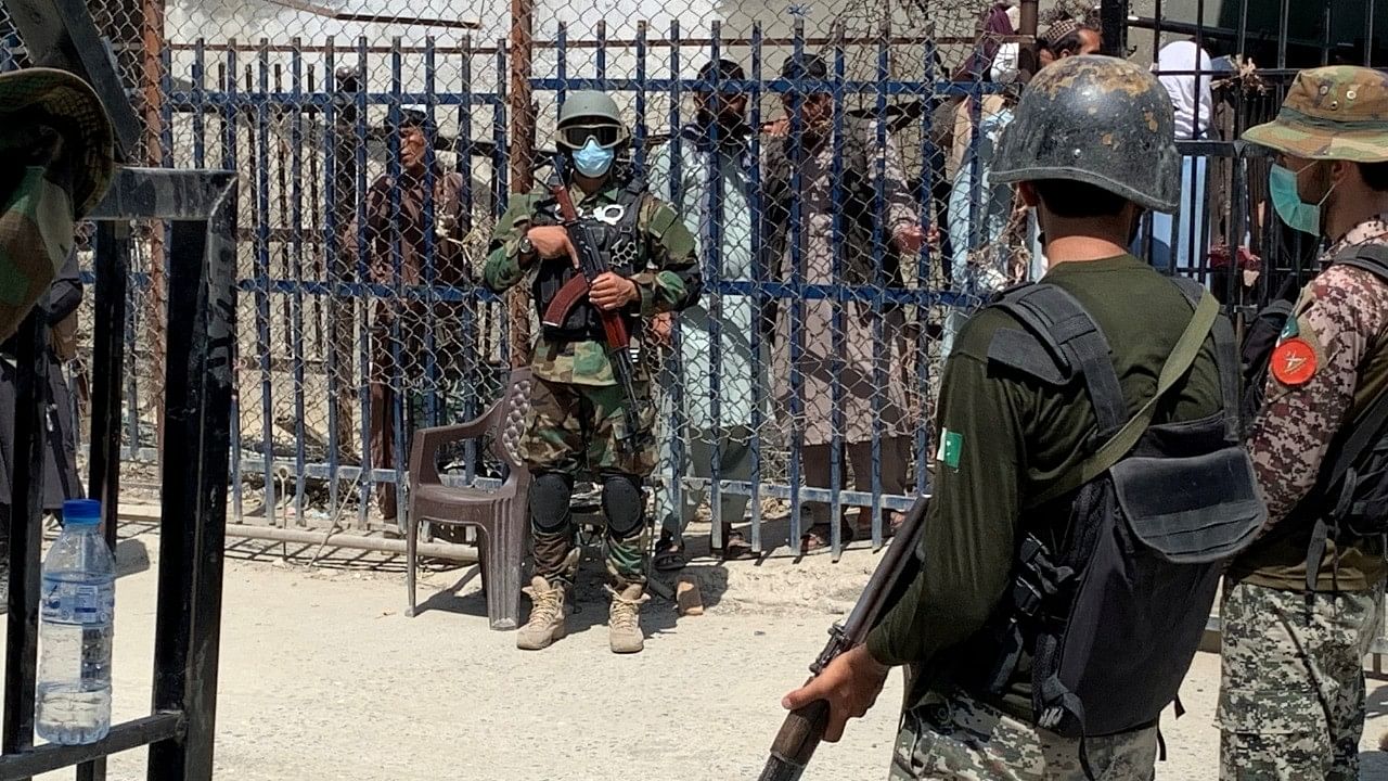 <div class="paragraphs"><p>Representative image showing Pakistani soldiers standing guard in front of a member of the Taliban force.</p></div>