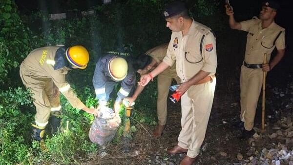 <div class="paragraphs"><p>Police and fire services personnel inspect an LPG cyclinder after an attempt was allegedly made to derail the Kalindi Express, heading towards Bhiwani from Prayagraj, by placing the LPG cylinder on the tracks, in the Shivrajpur area in Kanpur, on Sunday night, Sept. 8, 2024.</p></div>