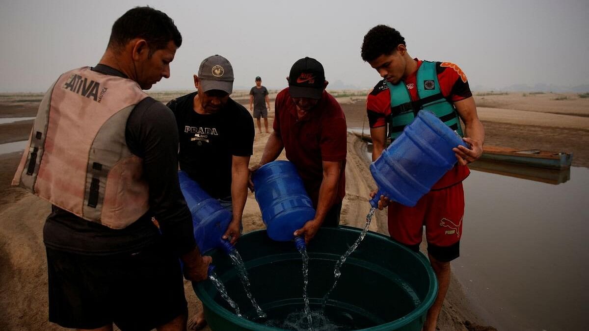 <div class="paragraphs"><p>River dwellers fill a tank of water on the sandbanks of Madeira river during worst drought of river in history in Humaita,&nbsp;Amazonas state, Brazil.</p></div>