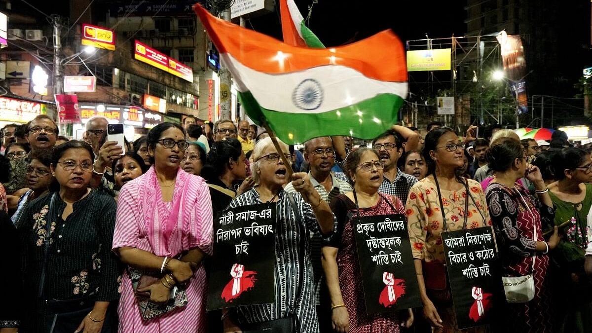 <div class="paragraphs"><p>People raise slogans during a protest over the alleged sexual assault and murder of a trainee doctor, in Kolkata.</p></div>