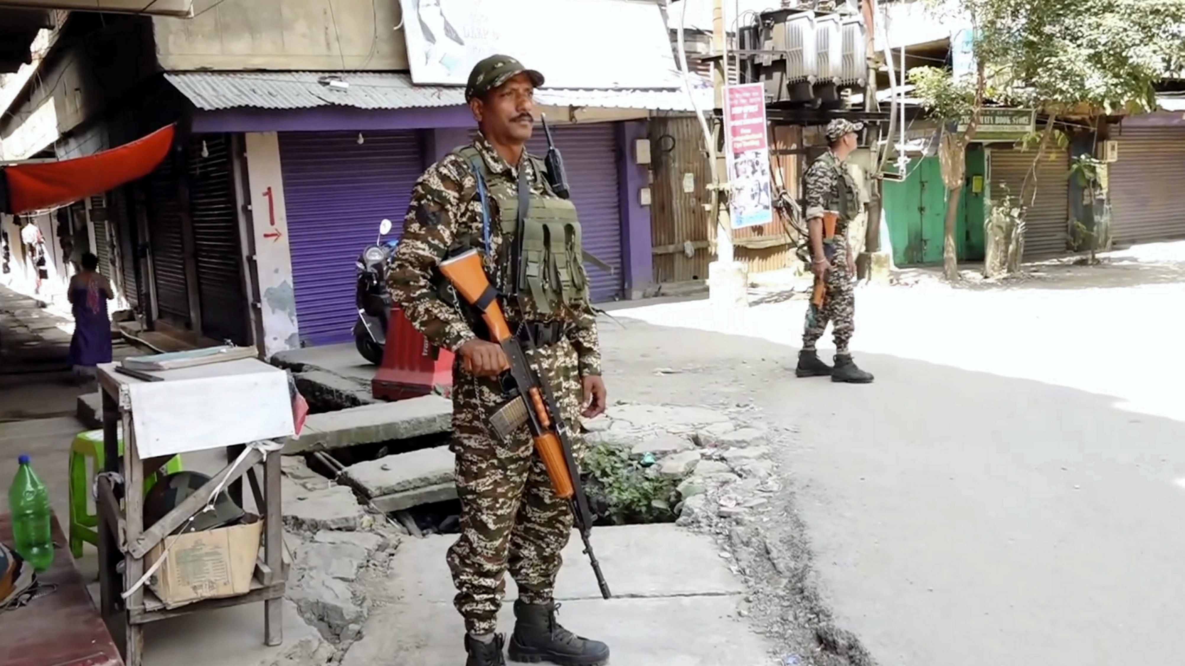 <div class="paragraphs"><p>Security personnel stand guard in Imphal on Monday</p></div>