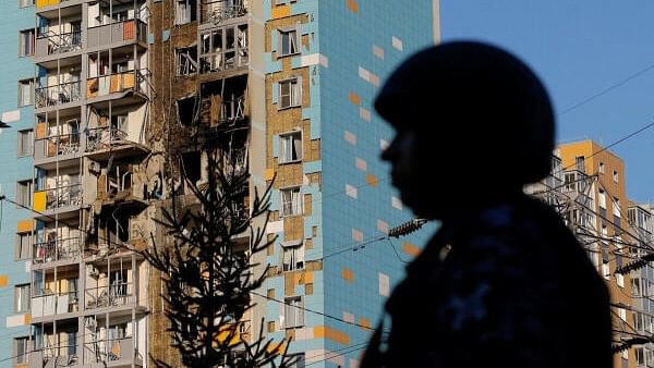 <div class="paragraphs"><p>A law enforcement officer stands guard near a damaged multi-storey residential building following an alleged Ukrainian drone attack in the course of Russia-Ukraine conflict, in Ramenskoye in the Moscow region, Russia September 10, 2024. </p></div>