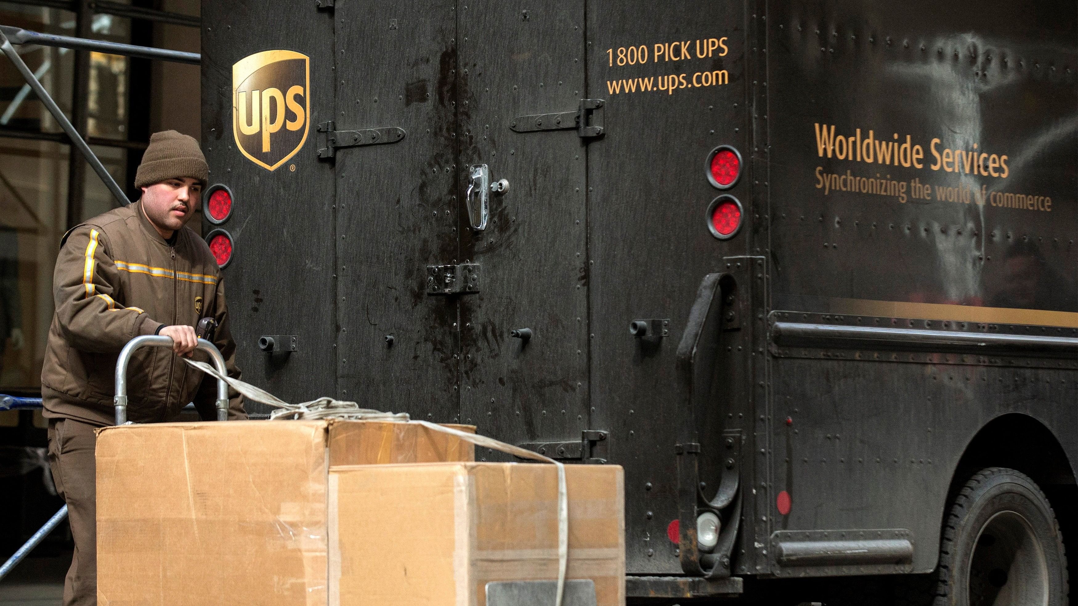 <div class="paragraphs"><p> A UPS delivery person offloads packages from a truck in New York's financial district March 5, 2014. </p></div>