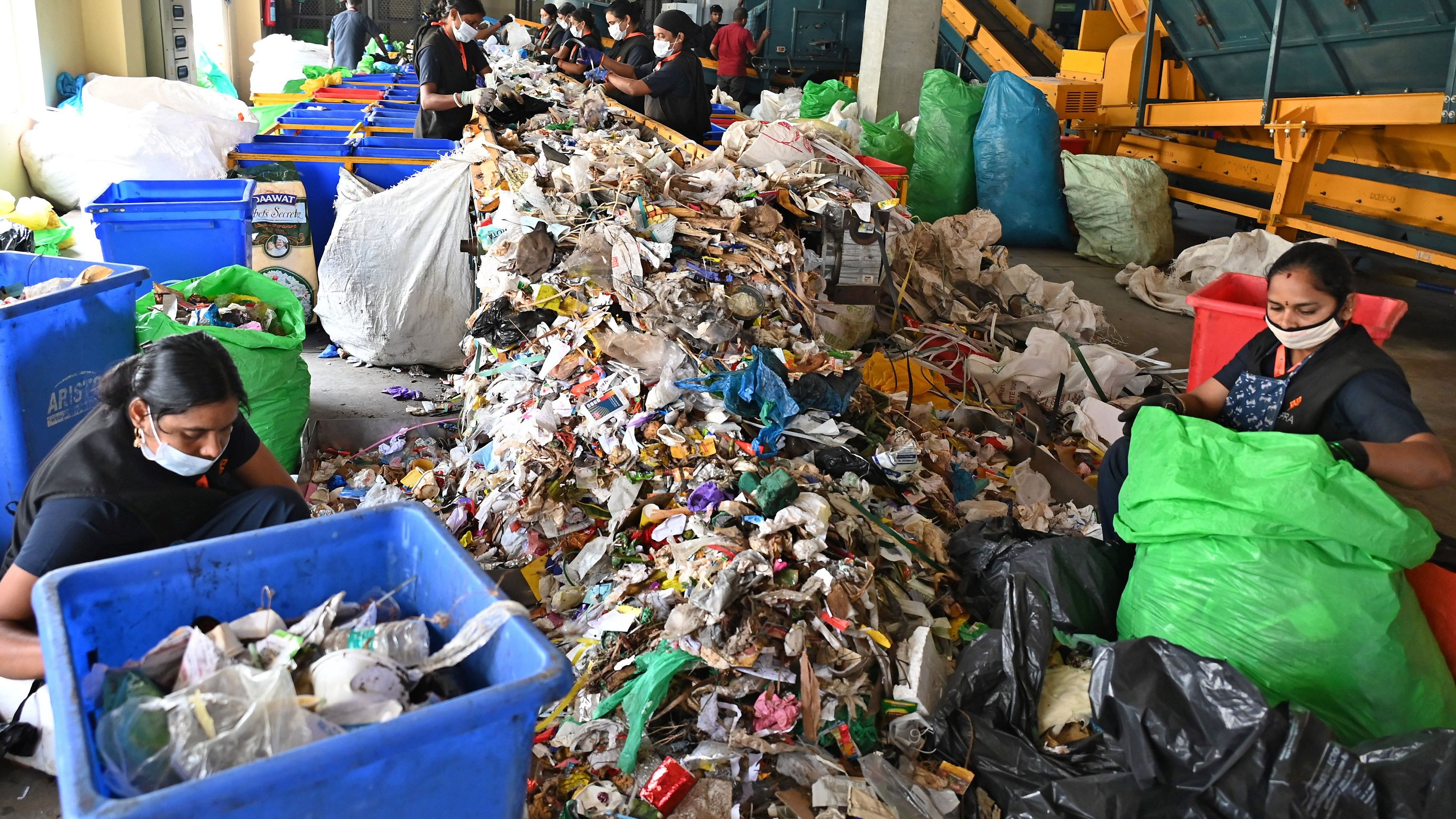 <div class="paragraphs"><p>Workers sort solid waste at a facility in the city. </p></div>