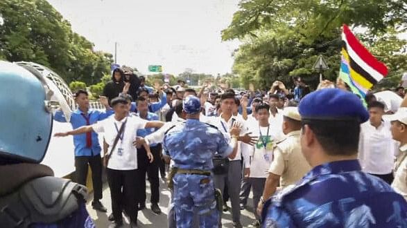 <div class="paragraphs"><p>Security personnel stop members of All Manipur Students' Union (AMSU) during a protest march against the recent violence in the state, in Imphal, Monday.&nbsp;</p></div>