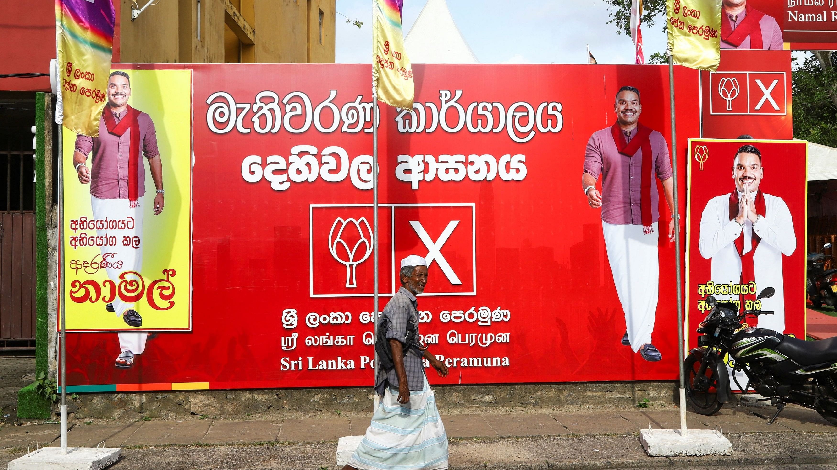 <div class="paragraphs"><p>A man walks past an election banner of presidential candidate Namal Rajapaksa outside the Sri Lanka Podujana Peramuna  party office, ahead of the upcoming presidential election scheduled for September 21, in Dehiwala, near Colombo, Sri Lanka, September 8, 2024. </p></div>