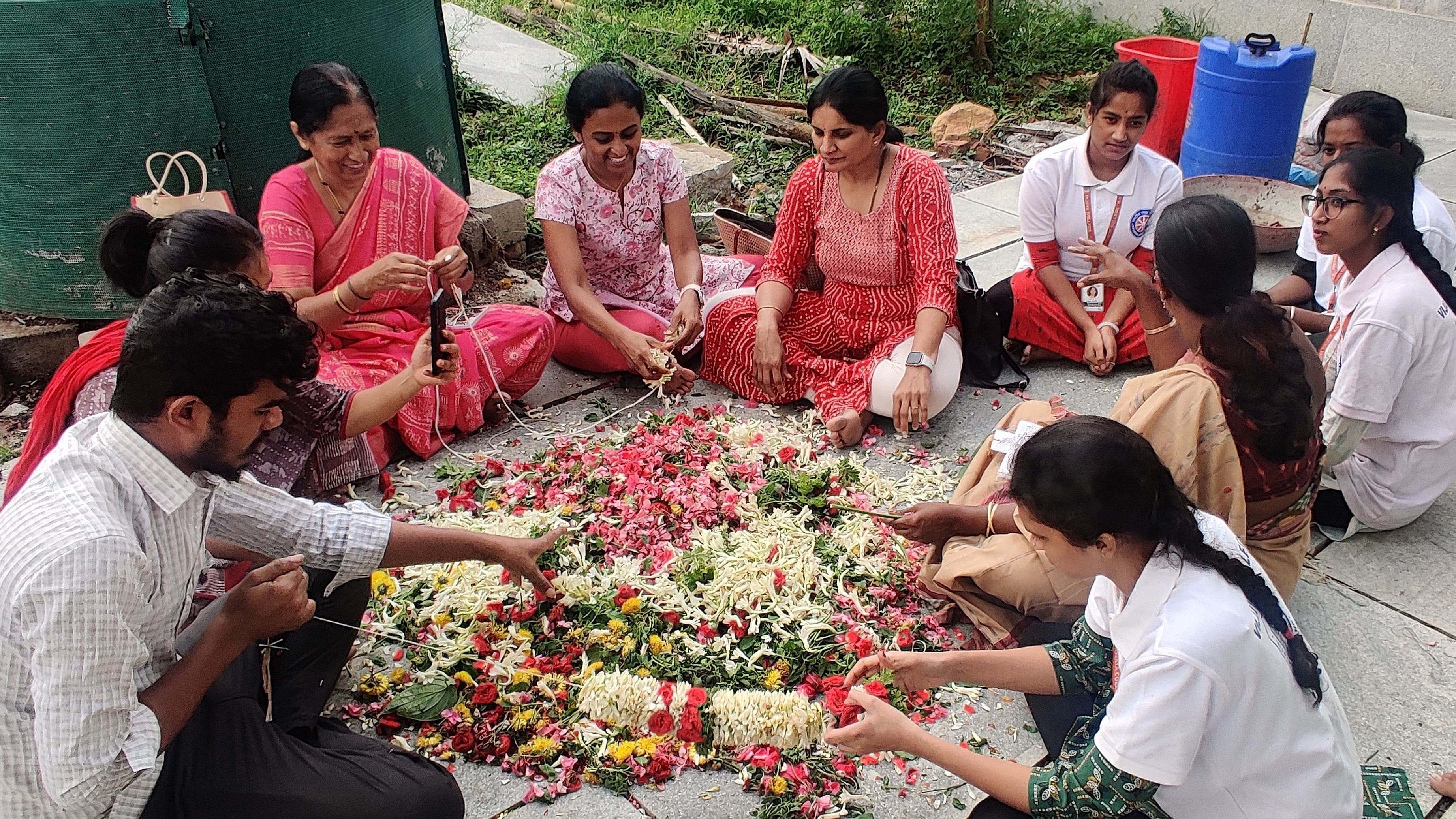 <div class="paragraphs"><p>Volunteers destring flowers from garlands at the Nageshvara Temple in Begur.</p></div>