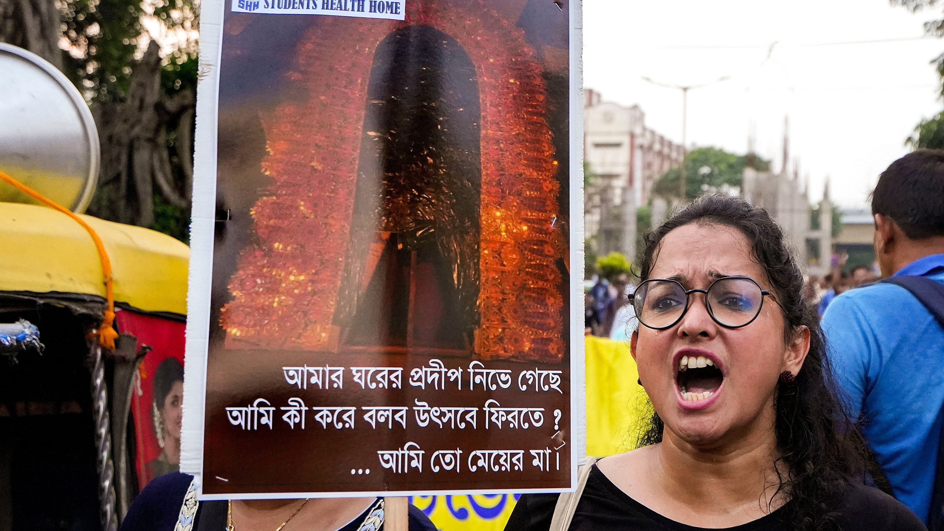 <div class="paragraphs"><p>Doctors display placards during a protest dharna over the RG Kar Hospital rape and murder incident, in Kolkata.</p></div>