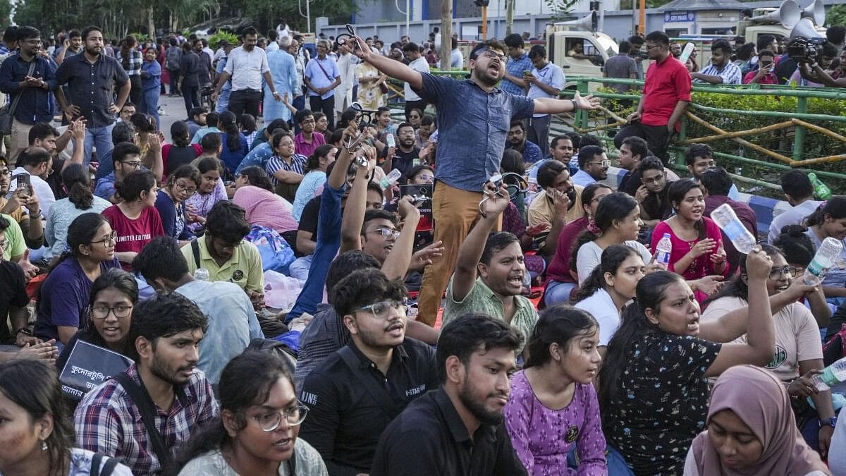 <div class="paragraphs"><p>Junior doctors shout slogans as they sit on a dharna after the police stopped their protest march towards Swasthya Bhawan over the RG Kar Hospital rape and murder incident, in Kolkata.&nbsp;</p></div>