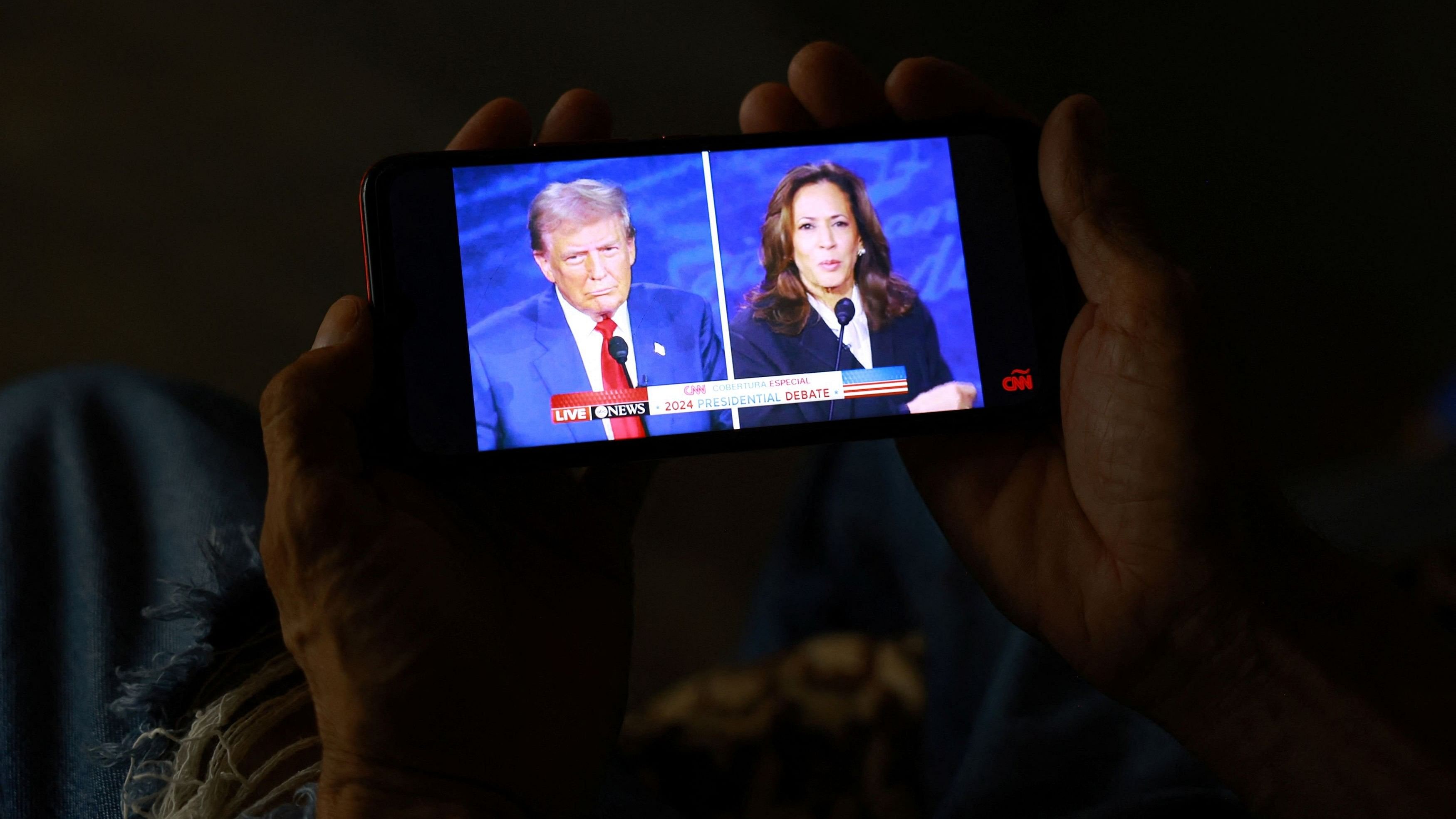 <div class="paragraphs"><p>A migrant, seeking to reach the United States and request asylum, watches the presidential debate between the Republican presidential nominee, former US President Donald Trump and the Democratic presidential nominee, US Vice President Kamala Harris, on a mobile phone screen inside the El Buen Samaritano shelter in Ciudad Juarez, Mexico.</p></div>