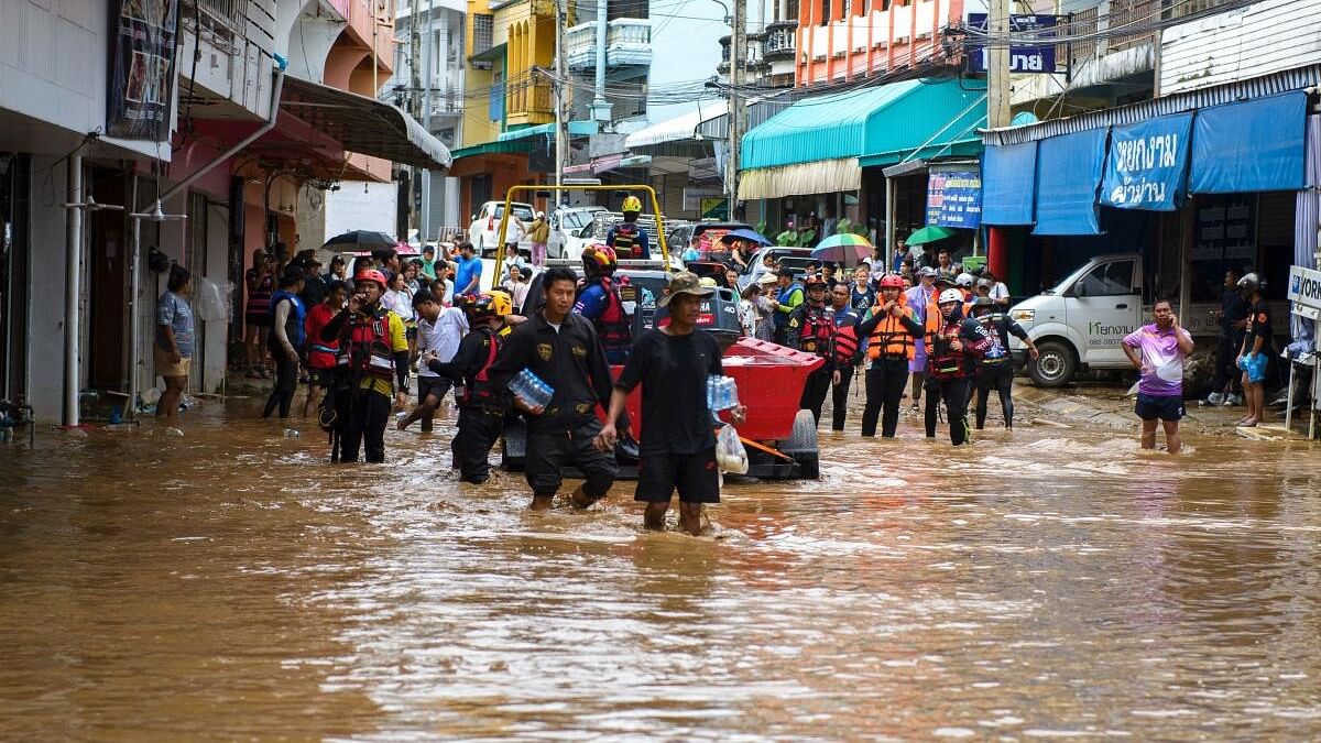 <div class="paragraphs"><p>Rescue workers help stranded people from a flooded area at the border town of Mae Sai, following the impact of Typhoon Yagi, in the northern province of Chiang Rai, Thailand, September 11, 2024.</p></div>