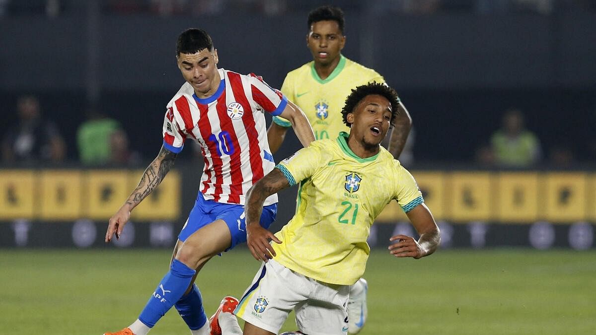 <div class="paragraphs"><p>Paraguay's Miguel Almiron in action with Brazil's Joao Pedro</p></div>