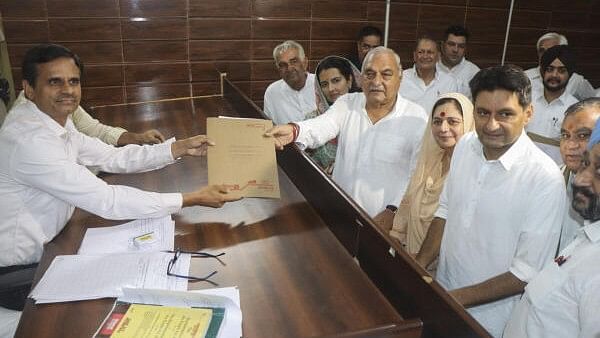 <div class="paragraphs"><p>Congress candidate Bhupinder Singh Hooda files his nomination papers for Haryana Assembly elections, in Rohtak, Wednesday, Sept 11, 2024. His son and party MP Deepender Singh Hooda is also seen.</p></div>