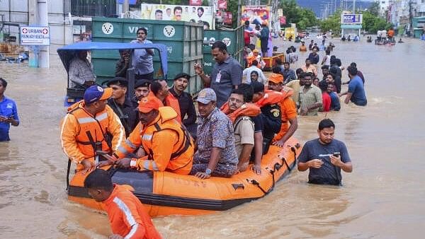 <div class="paragraphs"><p>Vijayawada City Police Commissioner IPS SV Rajasekhara Babu with others reviews the rescue operation at a flood-affected area after heavy rainfall, in Vijayawada, Andhra Pradesh. </p></div>