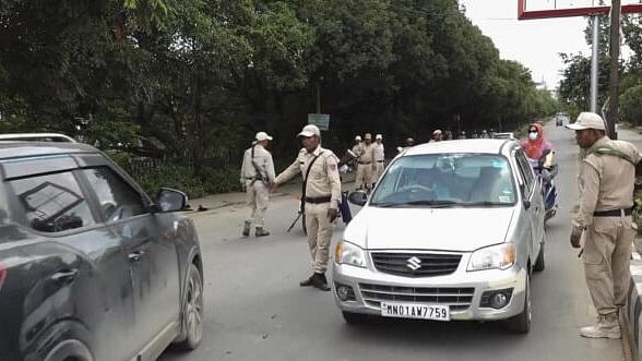 <div class="paragraphs"><p>Police personnel check vehicles amid curfew, which was imposed in the state's capital on Tuesday after students clashed with security forces during their march to Raj Bhavan, in Imphal.</p></div>