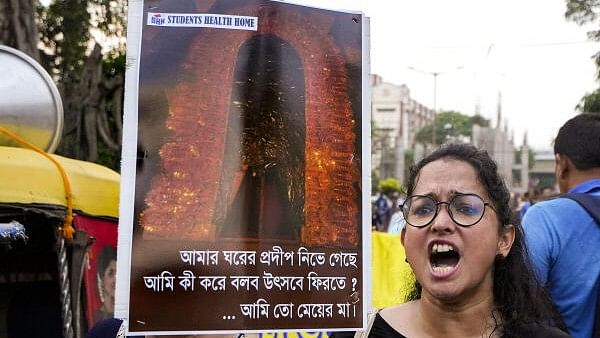 <div class="paragraphs"><p>Doctors display placards during a protest dharna over the RG Kar Hospital rape and murder incident, in Kolkata.</p></div>