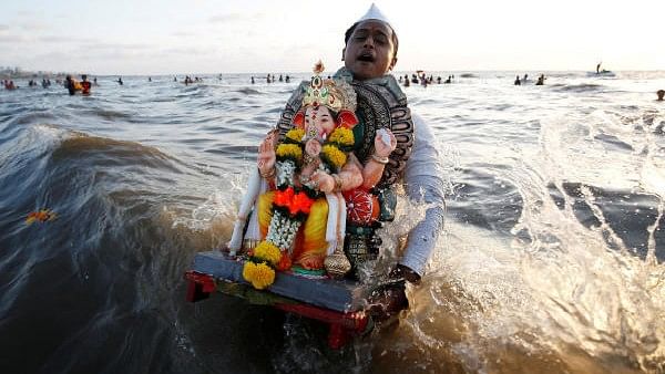 <div class="paragraphs"><p>A devotee carries an idol of the Hindu god Ganesh, the deity of prosperity, for immersion </p></div>