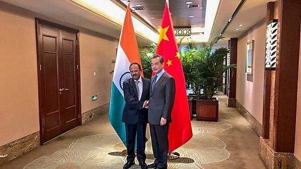 <div class="paragraphs"><p>National Security Advisor Ajit Doval shakes hands with Chinese Foreign Minister Wang Yi.</p></div>