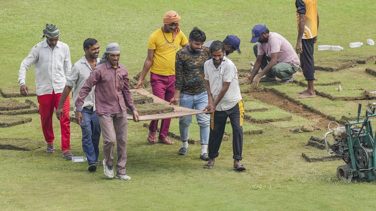 <div class="paragraphs"><p>Groundsmen put grass patches on the ground before the start of the second day of one-off Test match between Afghanistan and New Zealand, in Greater Noida.</p></div>